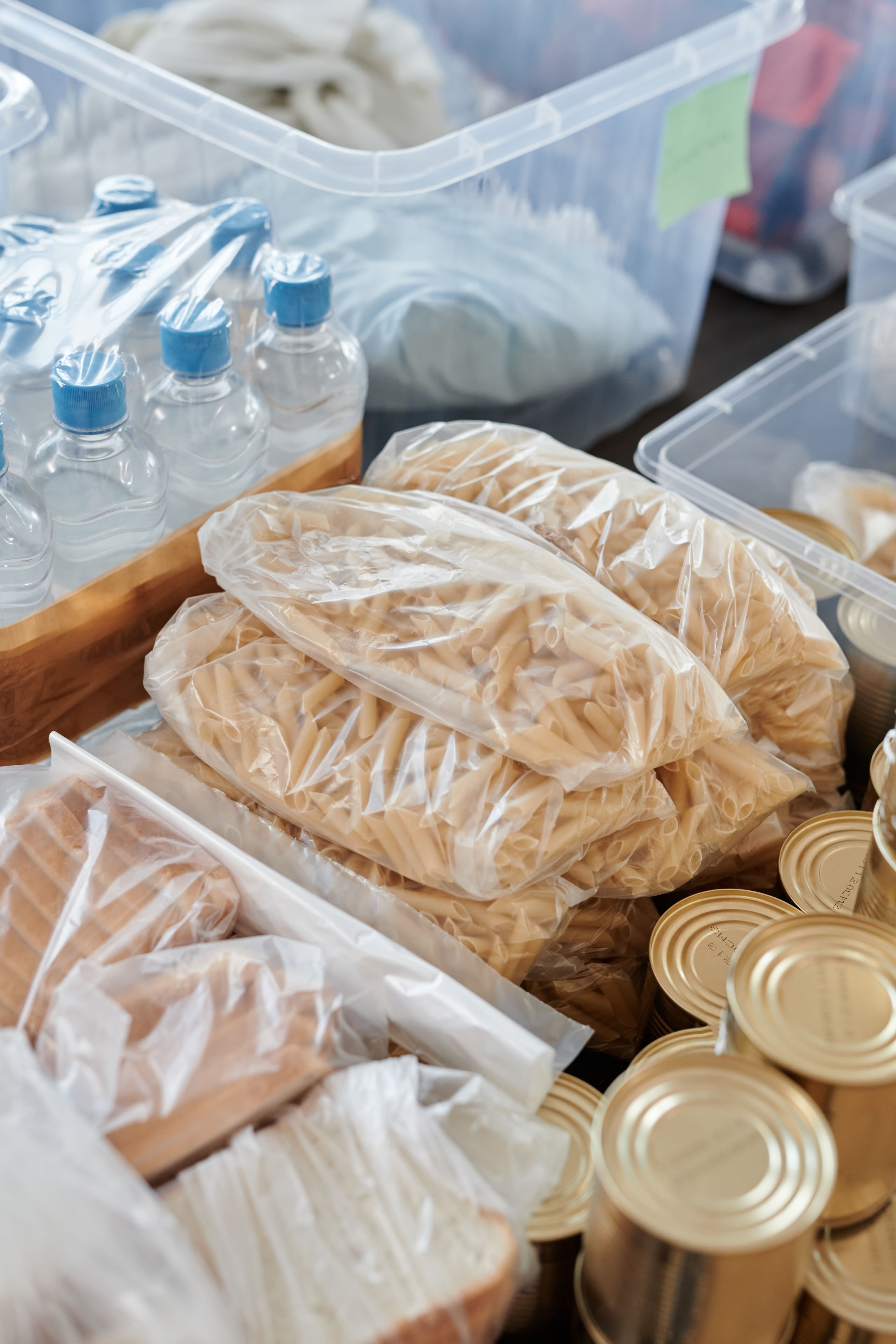 Neatly packed food supplies including pasta, canned goods, and water